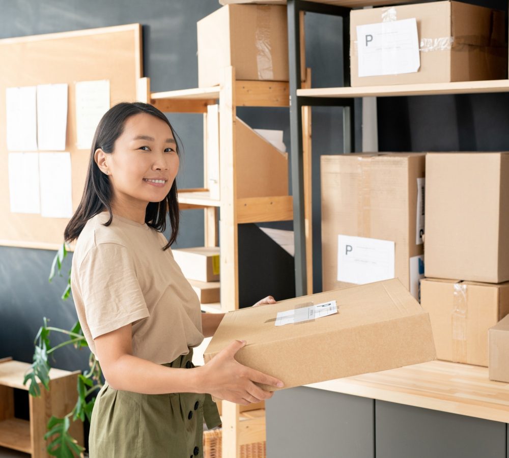 smiling-youngworker-of-post-office-or-storage-room-carrying-order-of-client.jpg